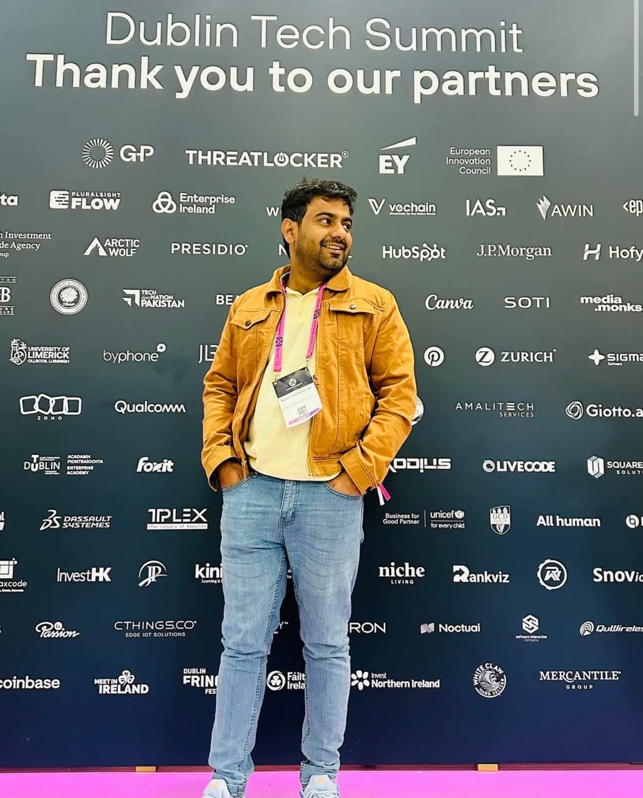 Muhammad Sultan Ali wearing a brown jacket at a technology event